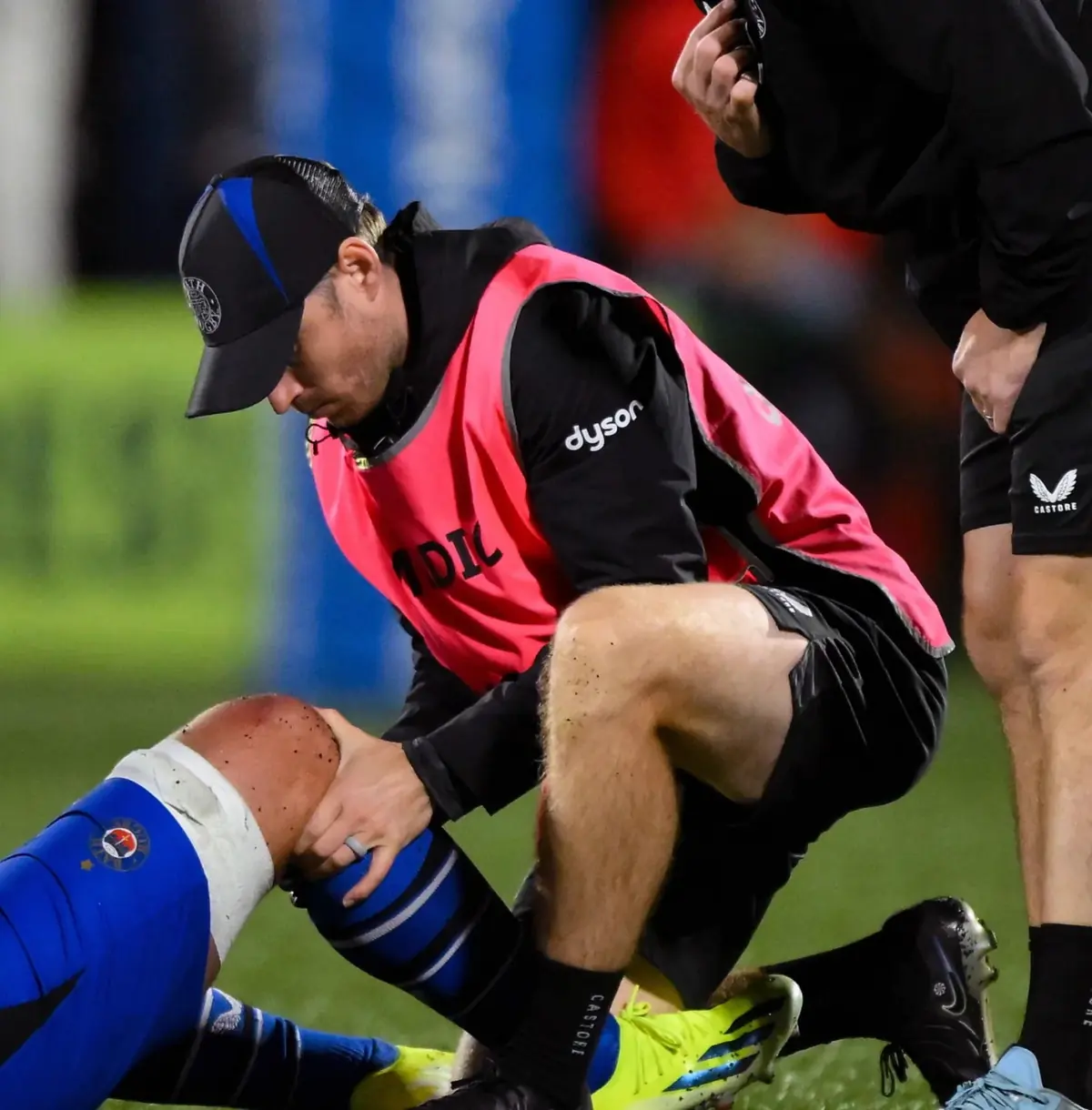 George Gauntlett assessing a rugby player's knee during a match